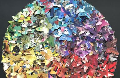 A circle composed of hundreds of multicoloured paper butterflies
